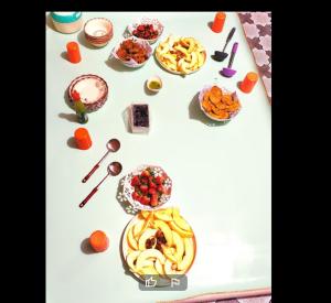 a table with many different types of food on it at High City Hotel in Dargai