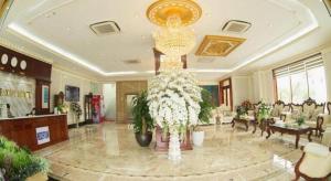 a lobby with a large chandelier in a building at Bacninh Charming Hotel in Bồ Sơn