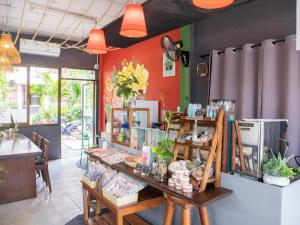 a store with a table with food on it at OYO 567 U Residence in Ban Lamai