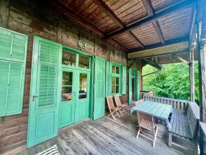 a porch of a house with a table and chairs at Haus Tanegg in Innsbruck