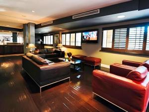 a living room with two couches and a tv at Hotel Solaire Los Angeles in Los Angeles