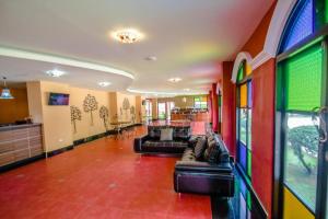 a living room with colorful walls and couches at Maladee Hotel in Ban Nong Phra Lae