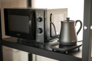 a coffee maker on a shelf next to a microwave at Sakura Moana - Vacation STAY 06385v in Fukaura