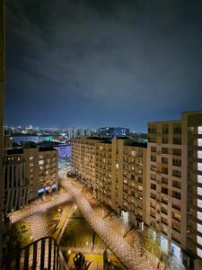 a view of a city at night with buildings at Love Nest in Almaty