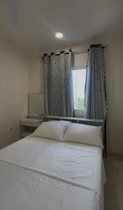 a bedroom with a white bed and a window at STO Tower A Hulhumale Phase 2 in Hulhumale