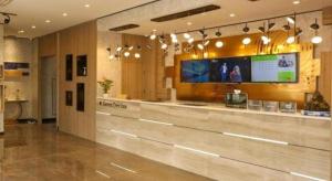 a lobby of a hospital with a tv on the wall at GreenTree Inn Suzhou Changshu Southeast Development Zone Southeast Avenue in Gujiashuigou