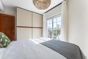 a bedroom with a bed and a large window at Oasis Mijas Centro in Mijas