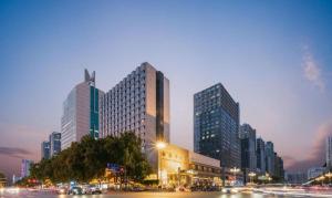 a city at night with tall buildings and cars at Shijiazhuang International Building Hotel in Shijiazhuang