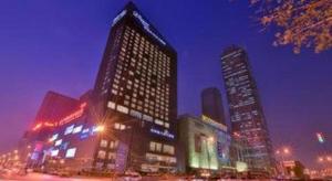 a city skyline with tall buildings at night at Shenyang Rayfont International Hotel in Shenyang