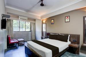 a bedroom with a large bed in a room at Hotel O Calangute-Baga Crossway Formerly Rustic Village in Calangute