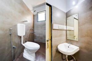a bathroom with a toilet and a sink at Hotel O Calangute-Baga Crossway Formerly Rustic Village in Calangute