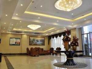 a lobby with a table in the middle of a room at GreenTree Inn Shanghai Jiading Newtown MaLu Subway Station Business Hotel in Jiading