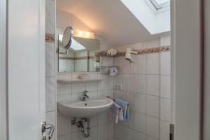 a bathroom with a sink and a mirror at Ferienwohnung Lengdobler - Burgi in Bad Kohlgrub +23 photos