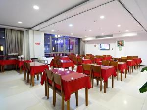 a dining room with red tables and chairs at GreenTree Inn Shanghai Jiading Newtown MaLu Subway Station Business Hotel in Jiading