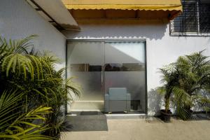 a glass door with a chair inside of a building at Hotel O Elite Stay in Pune