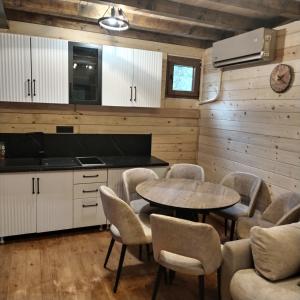 a kitchen with a table and chairs in a room at Brvnara Iva in Kolašin