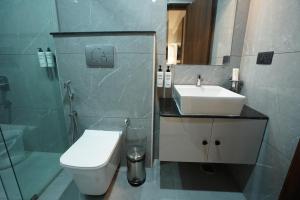 a bathroom with a sink and a toilet and a shower at 23 Urban Suites, Hitech City in Hyderabad