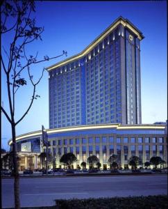 a large building with a clock on top of it at Dolton Changsha Spa Hotel in Ningxiang