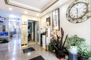 une grande horloge sur le mur d'un bâtiment dans l'établissement Ace Hotel, à To-dong