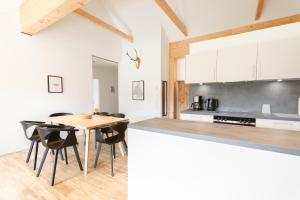 a kitchen and dining room with a table and chairs at Haus Weigt - Appartement das Grüne in Mariapfarr +17 photos