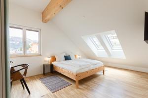 a bedroom with a bed and two windows at Haus Weigt - Appartement das Grüne in Mariapfarr