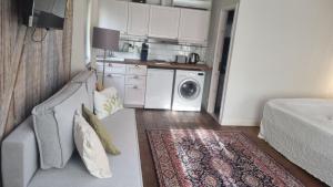 a living room with a couch and a kitchen at City Park Home in Pärnu