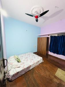 a bedroom with a bed and a ceiling fan at Sreeram house-2bhk flat near Bannerghatta in Kammasandra
