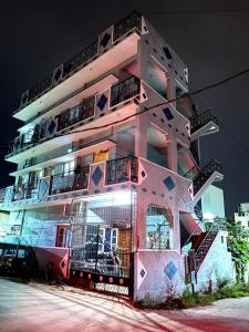 a tall pink building with stairs on the side of it at Sreeram house-2bhk flat near Bannerghatta in Kammasandra