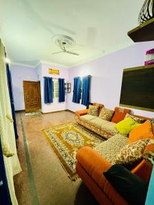 a living room with two couches and a flat screen tv at Sreeram house-2bhk flat near Bannerghatta in Kammasandra