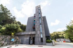 a tall building with aiger at Line Plus Hotel in Orijŏng