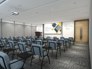 a room with a bunch of chairs and a screen at GreenTree Inn Guiyang Wudang District High-speed Railway East Station in Jinzhuzhen