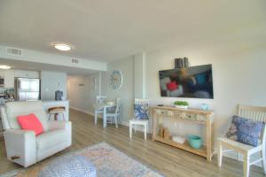 a living room with a couch and a chair at Verandas - 303 in Myrtle Beach