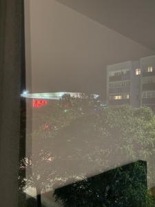 een uitzicht vanuit een raam van een stad 's nachts bij Apartament in Skorka