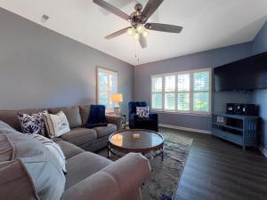 a living room with a couch and a ceiling fan at Canterbury Court - 6A in Myrtle Beach