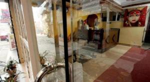 a glass window of a store with a view of a street at De Hotel Veda in Kathmandu +30 photos