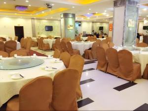 a banquet hall with tables and chairs in a room at Airport Liwan Hotel in Huadu