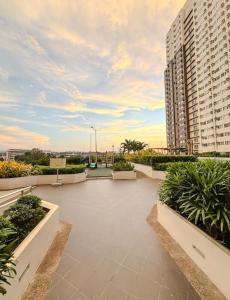 a large patio with plants and a large building at Emetheria Residence CDO in Cagayan de Oro