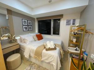 a small bedroom with a bed and a window at Emetheria Residence CDO in Cagayan de Oro +22 photos
