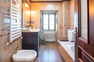a bathroom with a toilet and a sink and a tub at Casa Da Puza in Forcarei +23 photos