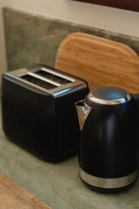 a black toaster sitting on top of a counter at Bird & Beach - 2 minutes walk to the beach in Suffolk Park +38 photos