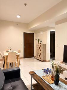 a living room with a table and a couch at 2BR Sunset View Deluxe Suite in Manila