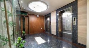 a hallway of a building with a glass door at Hotel Head-One in Ŭijŏngbu-yŏk +234 photos