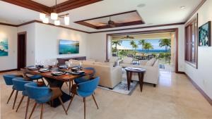 a dining room and living room with a table and chairs at ❤PiH❤ A Sea-nic Escape Stunning Ocean View Mauna Kea Resort eBikes in Hapuna Beach