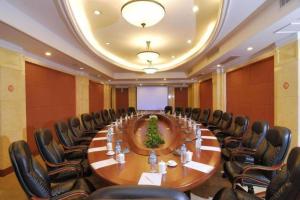 a large conference room with a long table and chairs at Hubei Poly Hotel in Wuhan