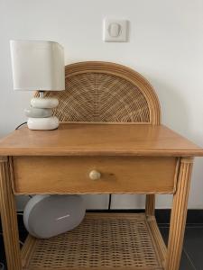 a wooden desk with a lamp on top of it at Appartement en bord de mer in Sainte-Maxime