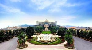 a large building with a fountain in the middle of a park at Evergrande Hotel Guangzhou Zengcheng in Zhongxin