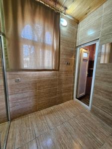 a large room with a shower with wooden walls at Glorious House Goreme in Nevsehir +127 photos