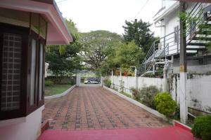 a brick walkway in front of a house at Tree Fort Homestay in Cochin