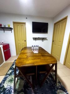 a room with a wooden table with glasses on it at Modern 2BR Escape Overlooking the Iloilo River in Mandurriao