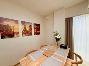 a dining room table with two chairs and a window at 晴天ハイム in Kokubunji